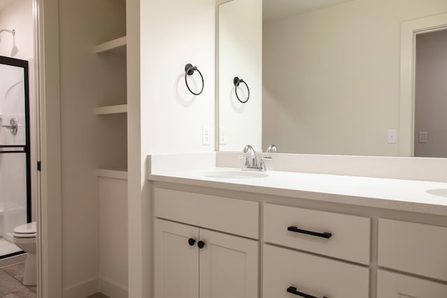 bathroom featuring vanity and toilet