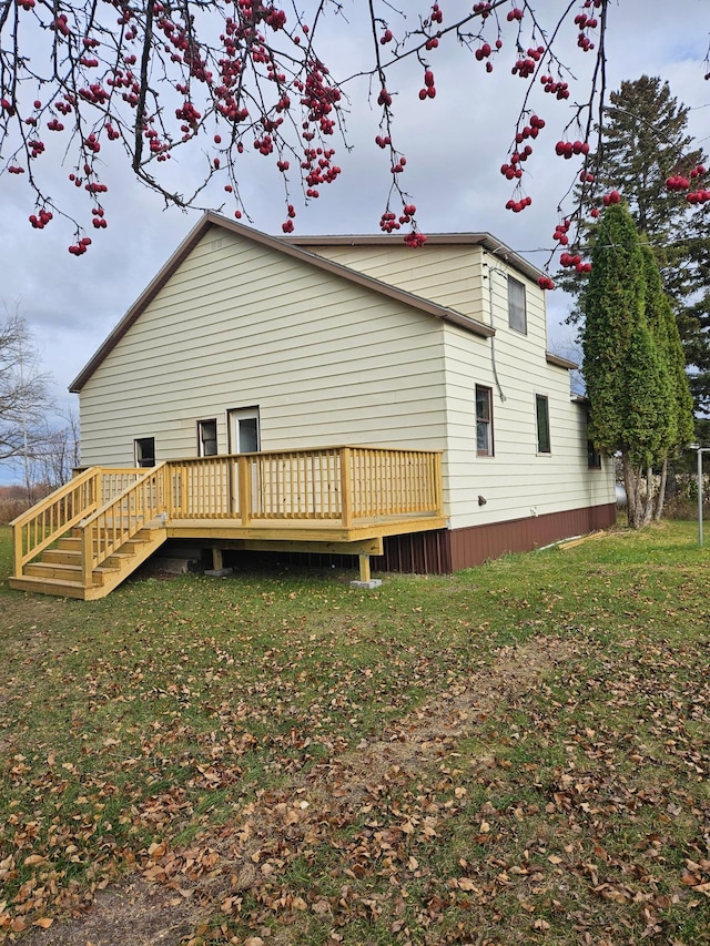 back of house with a lawn and a wooden deck