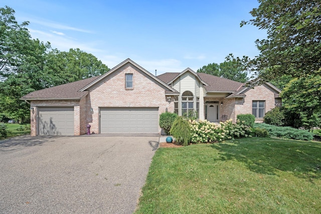 view of front of home featuring a front yard and a garage