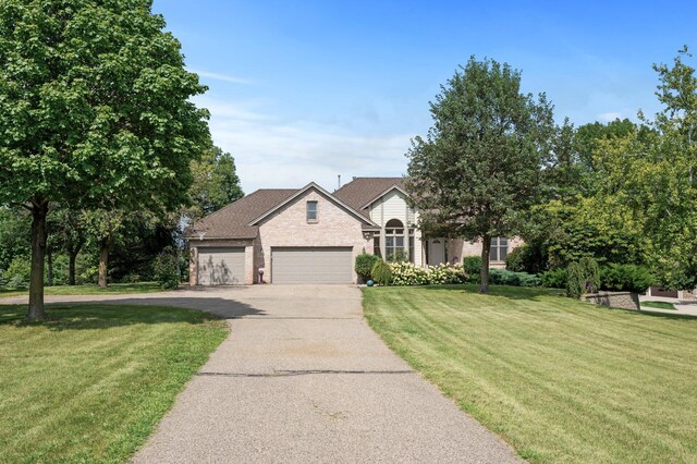 view of front of house with a front lawn and a garage