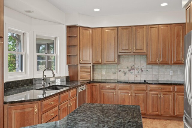 kitchen featuring sink, a healthy amount of sunlight, stainless steel dishwasher, and dark stone counters