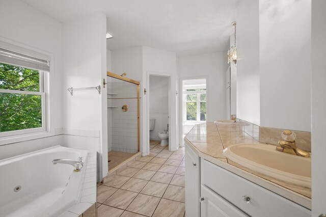 full bathroom with tile patterned floors, independent shower and bath, vanity, and toilet