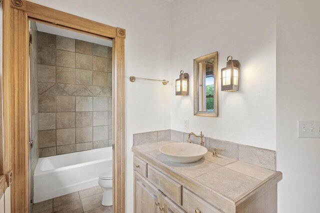 bathroom featuring tile patterned floors, toilet, and vanity