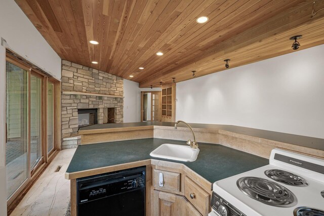 kitchen featuring light hardwood / wood-style floors, sink, range, black dishwasher, and a stone fireplace