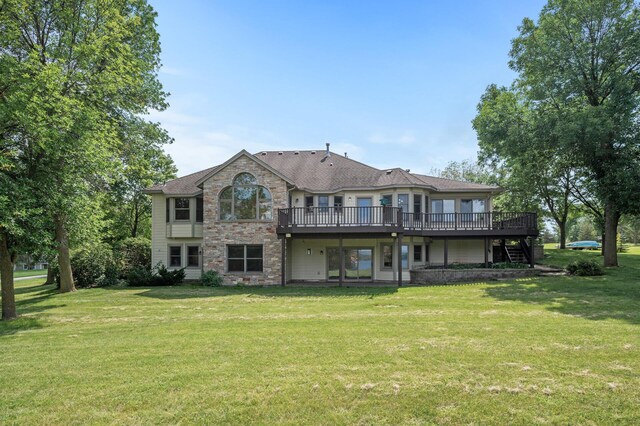 back of house featuring a deck and a yard