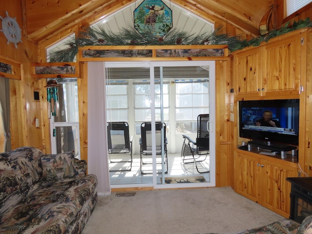 living room with lofted ceiling with beams and carpet floors