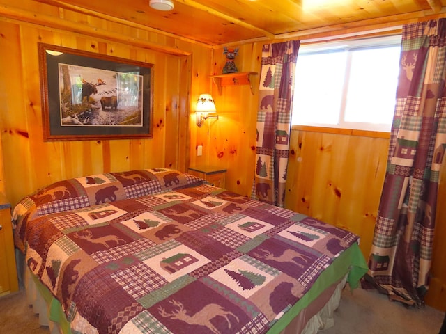 bedroom with carpet floors, wooden walls, and wood ceiling