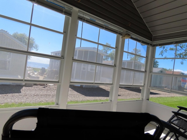 unfurnished sunroom with lofted ceiling