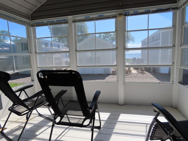 sunroom / solarium featuring vaulted ceiling