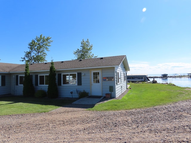 view of front of home featuring a front yard and a water view