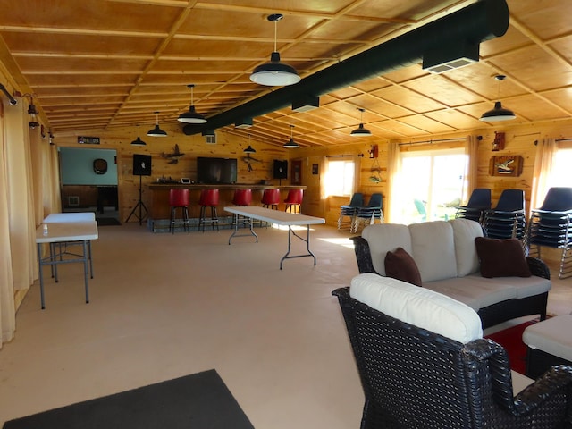 game room with wooden walls and vaulted ceiling