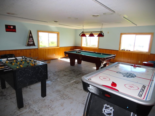 game room with plenty of natural light, wood walls, and pool table