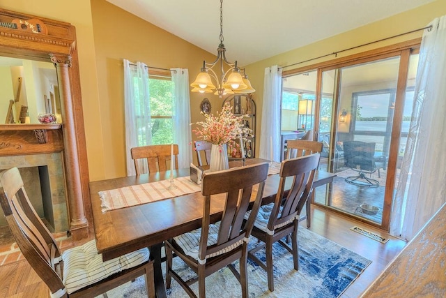 dining room with lofted ceiling, light wood-type flooring, and visible vents