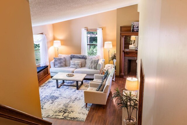 living room with dark wood-style floors and a textured ceiling