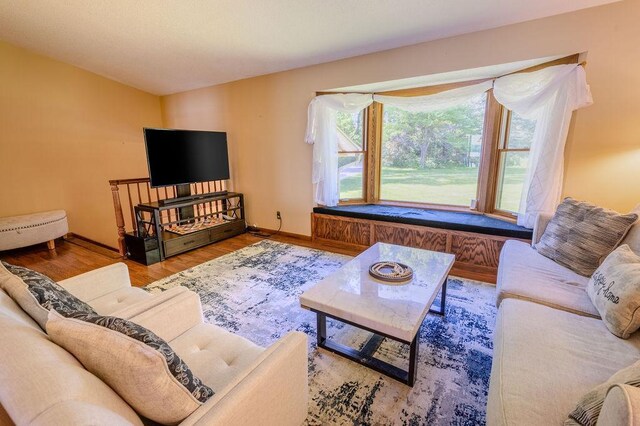 living area with wood finished floors and baseboards