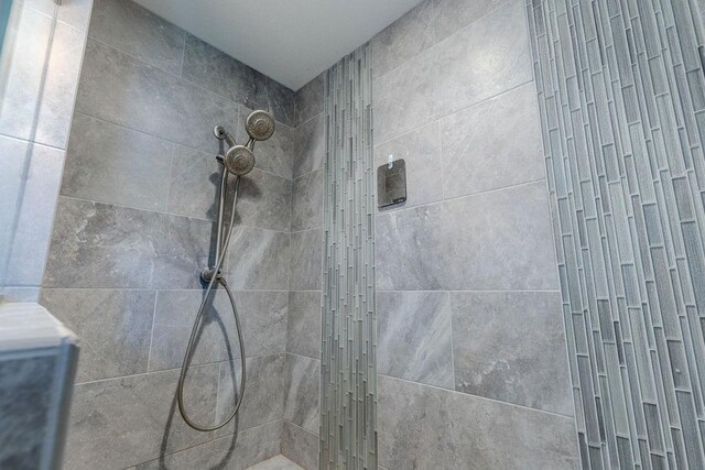 bathroom with a tile shower