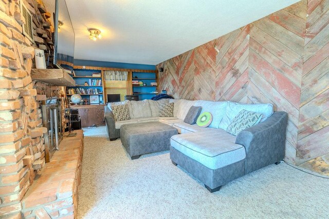 carpeted living area with wooden walls