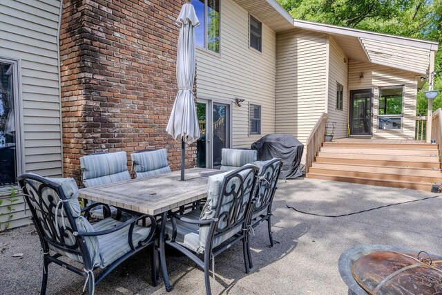 view of patio / terrace with a grill, a deck, and outdoor dining space