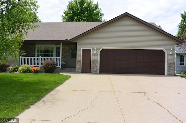 ranch-style home with a front yard, a garage, and a porch