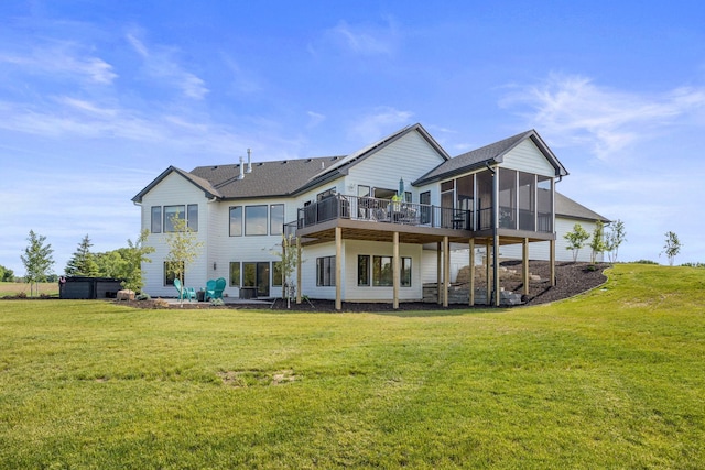 back of house featuring a patio, a sunroom, and a lawn