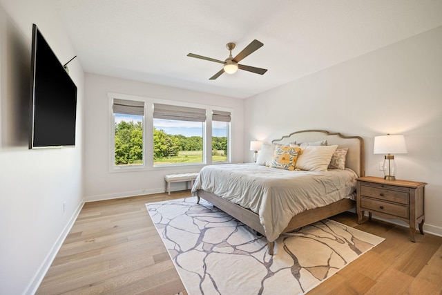 bedroom with ceiling fan and light hardwood / wood-style floors