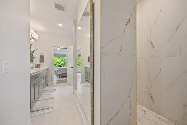 bathroom with vanity and tiled shower