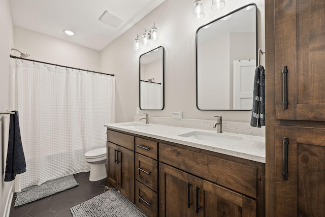 full bathroom featuring tile patterned floors, toilet, vanity, and shower / bath combo with shower curtain