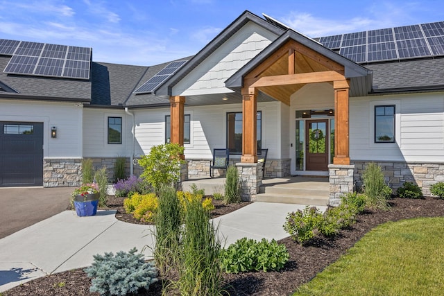 entrance to property with central AC unit, solar panels, and a porch