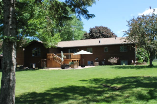 back of house featuring a yard and a deck