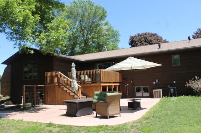 back of property with an outdoor living space, a patio, a deck, and central air condition unit