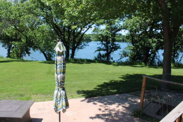 view of yard with a patio and a water view