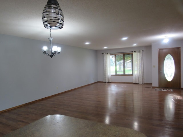 interior space featuring a notable chandelier and dark hardwood / wood-style flooring