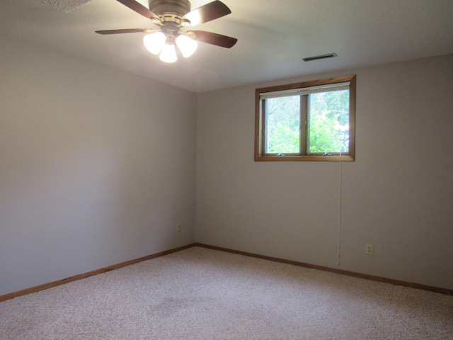 empty room featuring carpet flooring and ceiling fan