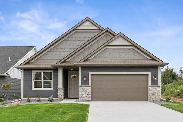 craftsman inspired home featuring a garage and a front lawn