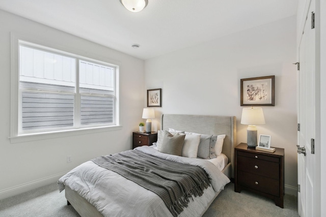 bedroom with light carpet and multiple windows