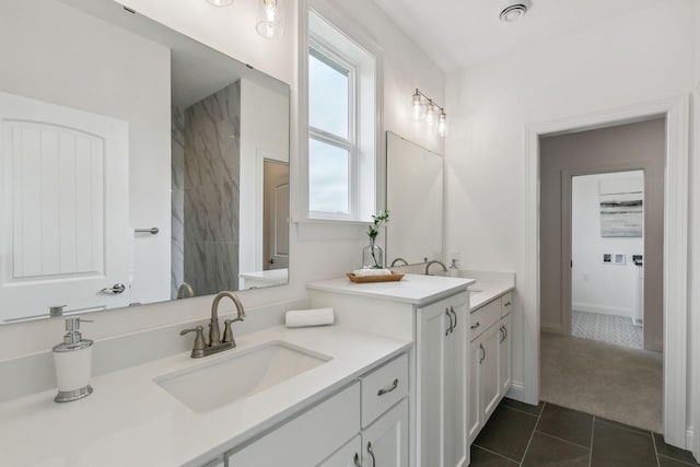 bathroom with tile patterned flooring, vanity, and a wealth of natural light