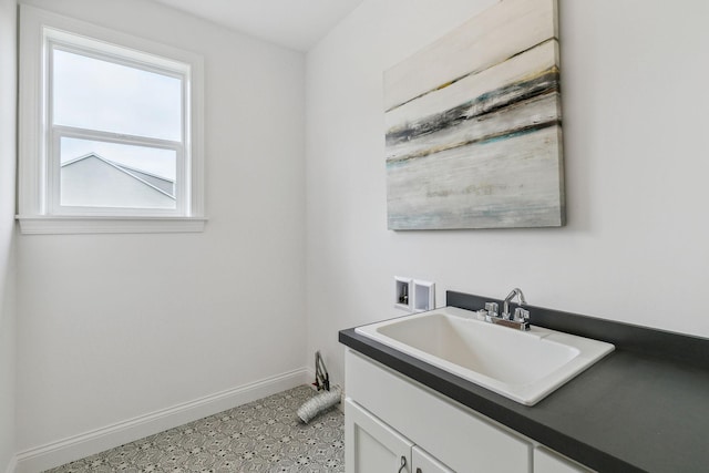 washroom featuring cabinets, sink, washer hookup, and tile patterned floors