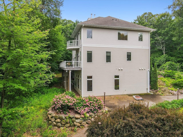 back of property with a balcony