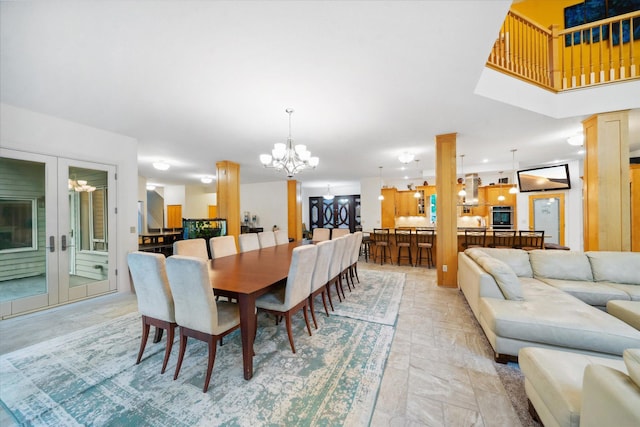 tiled dining room featuring a notable chandelier and ornate columns