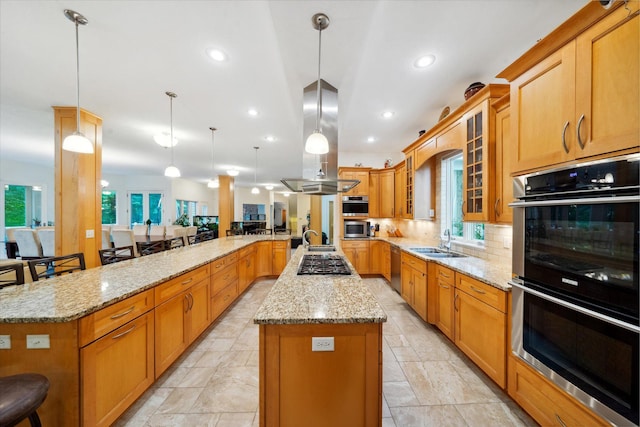 kitchen with light tile patterned floors, light stone countertops, appliances with stainless steel finishes, a kitchen bar, and kitchen peninsula