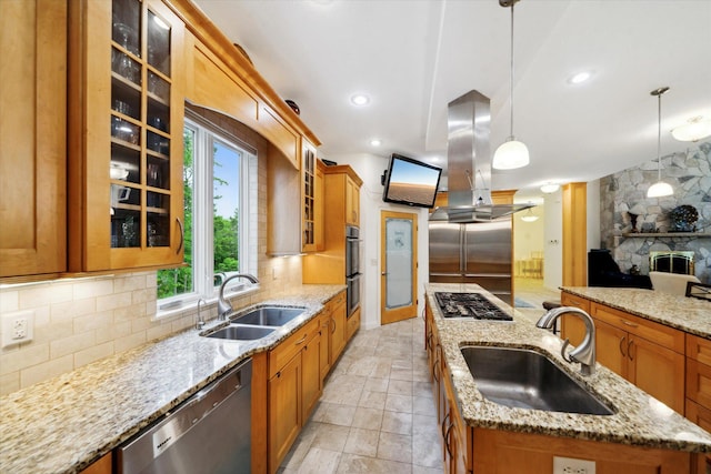 kitchen featuring decorative backsplash, a kitchen island with sink, island exhaust hood, and sink