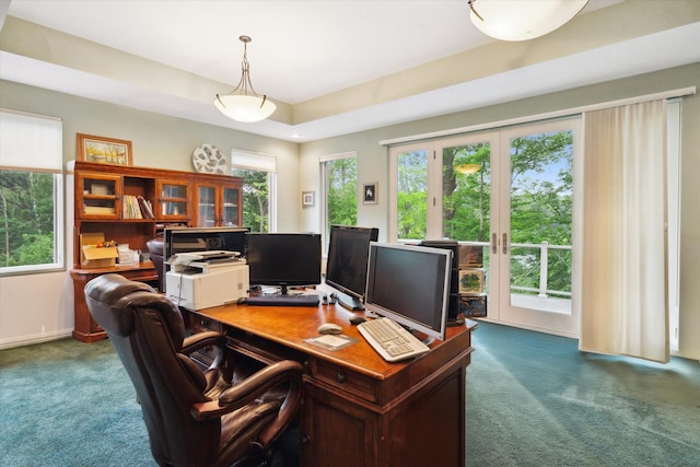 office with a raised ceiling, french doors, plenty of natural light, and carpet floors