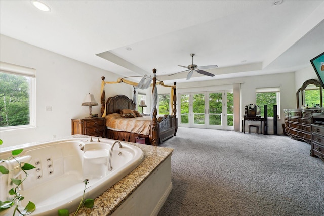 bedroom with carpet and a tray ceiling