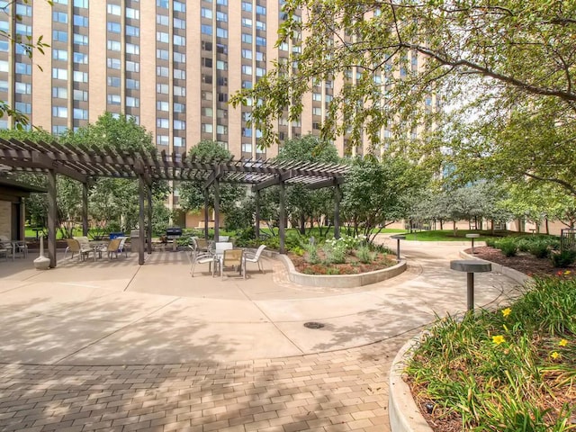 view of property's community with a pergola and a patio area