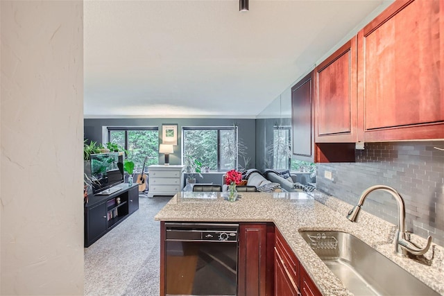 kitchen with kitchen peninsula, dishwasher, tasteful backsplash, and sink