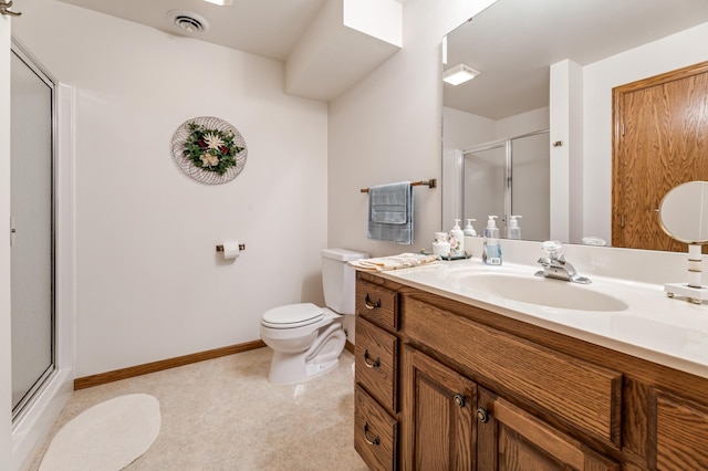 bathroom featuring vanity, toilet, and a shower with shower door