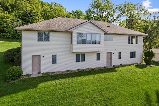 rear view of property featuring a yard