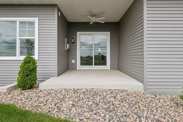 property entrance featuring a patio area and a ceiling fan