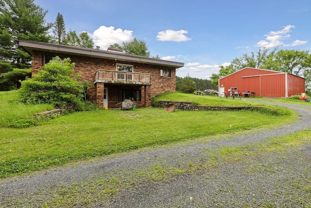 view of side of property featuring a yard and an outbuilding