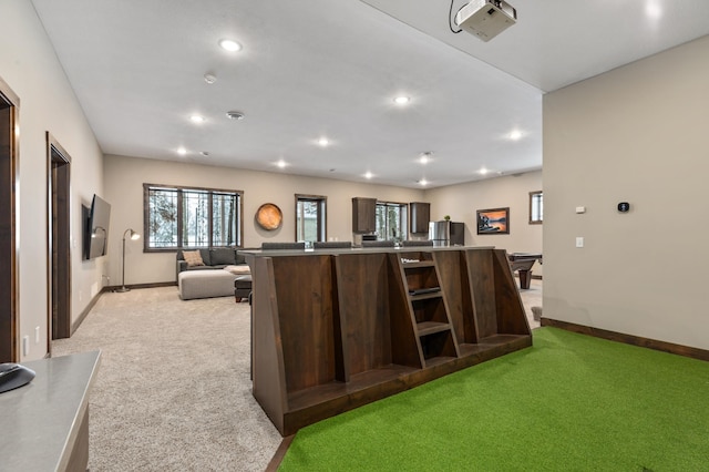 kitchen with dark brown cabinetry and light colored carpet